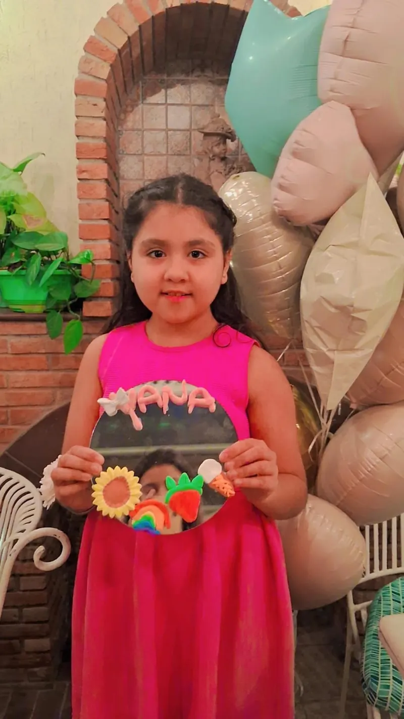 Finished mirror with clay lettering, a sunflower and fruit motifs made by a child at a birthday workshop in Delhi — Kraftykinni