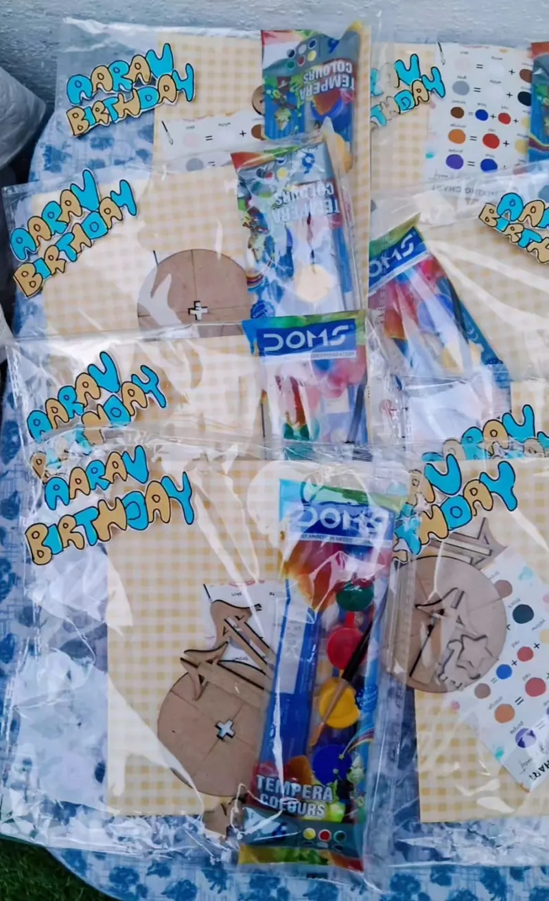 Personalised DIY kit bags with wooden pieces and tempera colours laid out for a kids' birthday workshop in Delhi — Kraftykinni